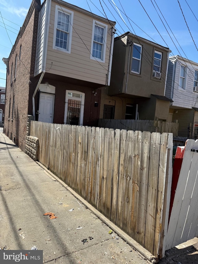 exterior space featuring a fenced front yard and brick siding