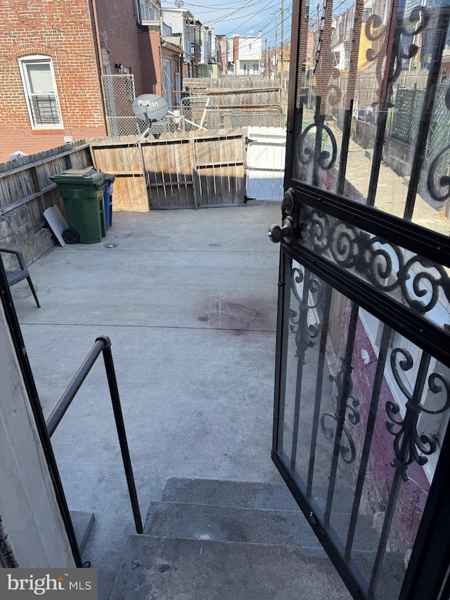 view of patio featuring a gate and fence