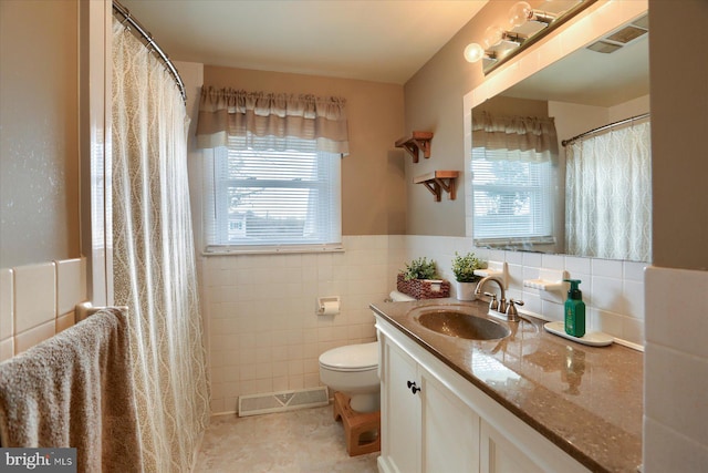 bathroom featuring visible vents, tile walls, a healthy amount of sunlight, and toilet