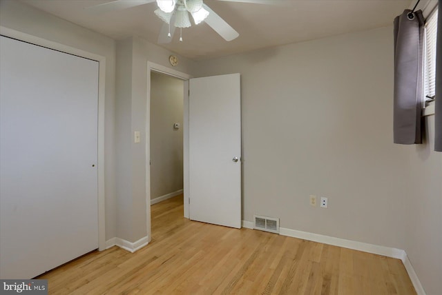 unfurnished bedroom featuring visible vents, baseboards, light wood-style floors, and ceiling fan