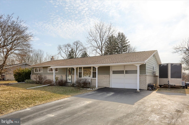 ranch-style house featuring aphalt driveway, a chimney, a front yard, and a garage