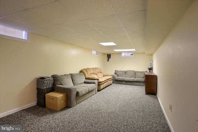 living room with visible vents, baseboards, a paneled ceiling, and carpet