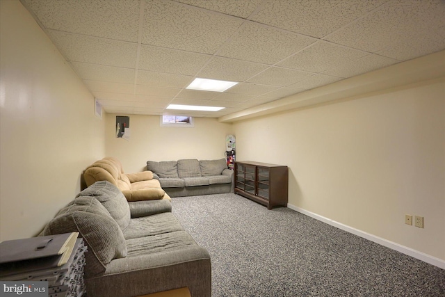 living area with a drop ceiling, baseboards, and carpet flooring