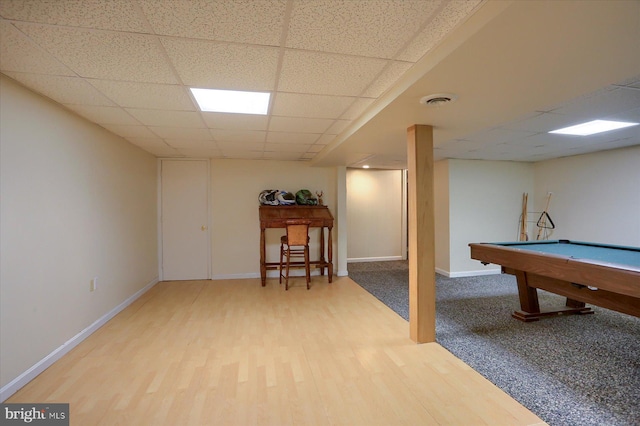 recreation room featuring baseboards, a paneled ceiling, visible vents, and wood finished floors