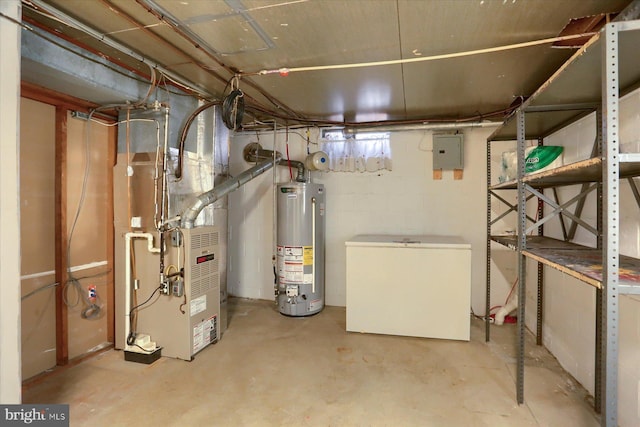 unfinished below grade area with fridge, heating unit, gas water heater, and electric panel