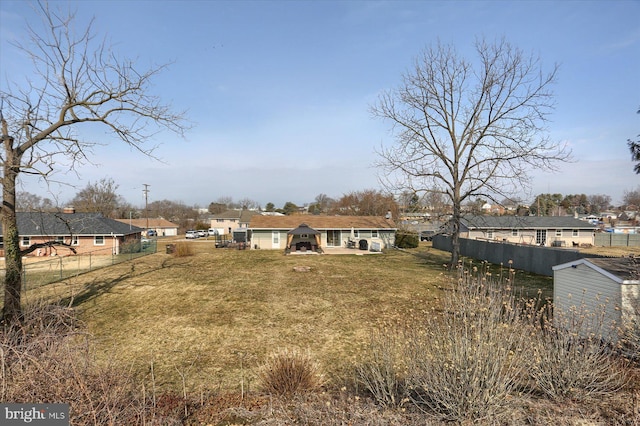 back of property with a yard and a fenced backyard