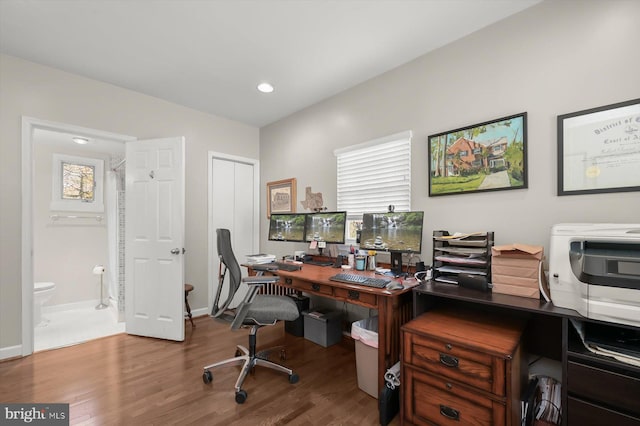 office featuring recessed lighting, baseboards, a healthy amount of sunlight, and wood finished floors