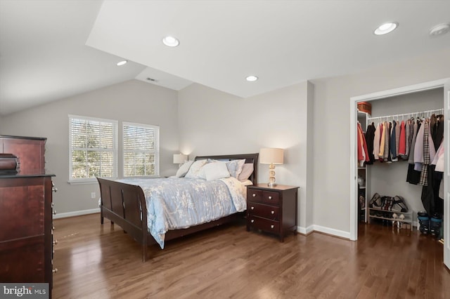 bedroom with recessed lighting, wood finished floors, a spacious closet, and vaulted ceiling