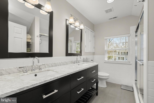 bathroom with visible vents, toilet, and a sink