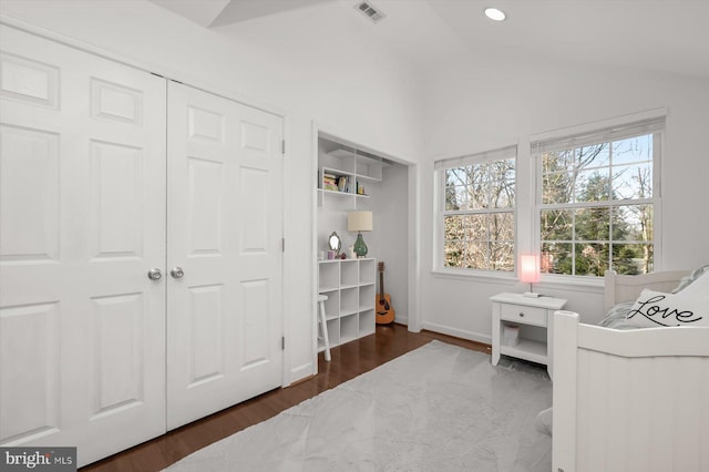 sitting room featuring visible vents, plenty of natural light, wood finished floors, and vaulted ceiling