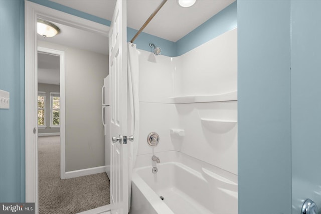 bathroom featuring baseboards and shower / bath combo with shower curtain