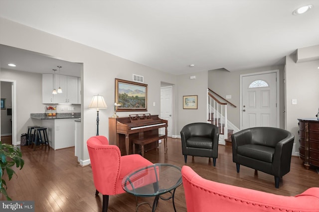 living area featuring visible vents, dark wood finished floors, recessed lighting, stairway, and baseboards