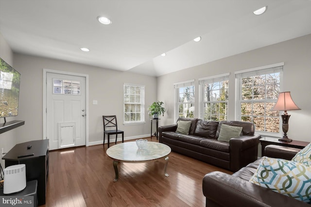 living room featuring vaulted ceiling, recessed lighting, baseboards, and wood finished floors