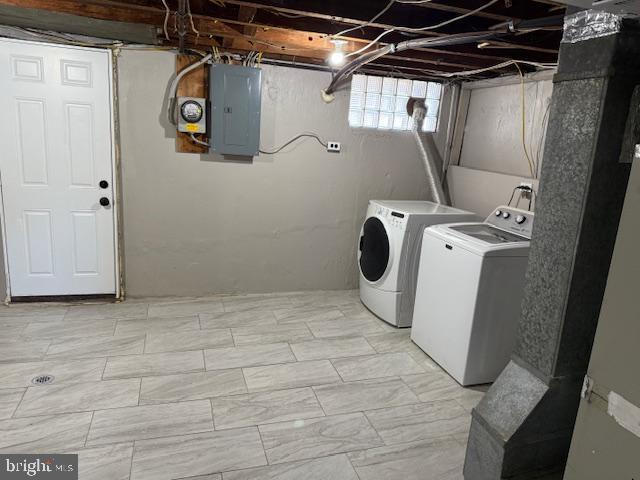 laundry area with electric panel, laundry area, and washing machine and dryer