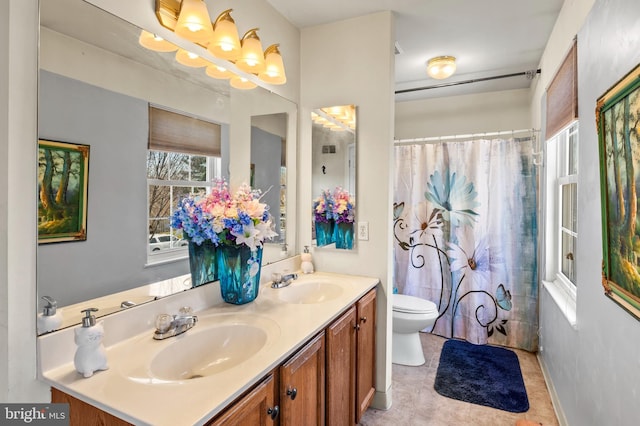 full bath featuring a sink, toilet, double vanity, and tile patterned flooring