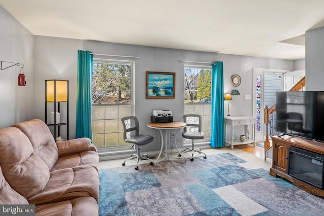 living area with plenty of natural light and baseboards