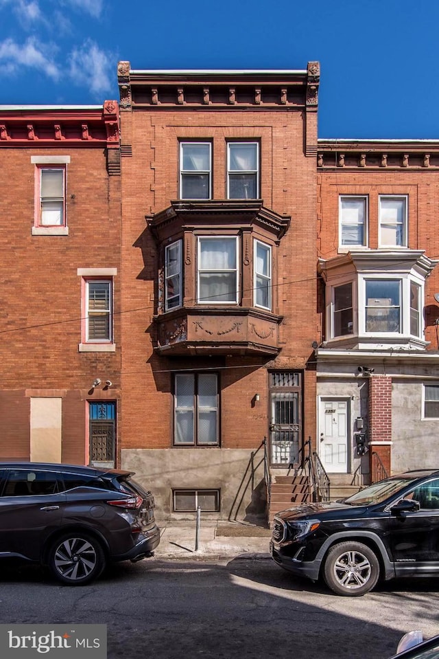 view of property featuring brick siding