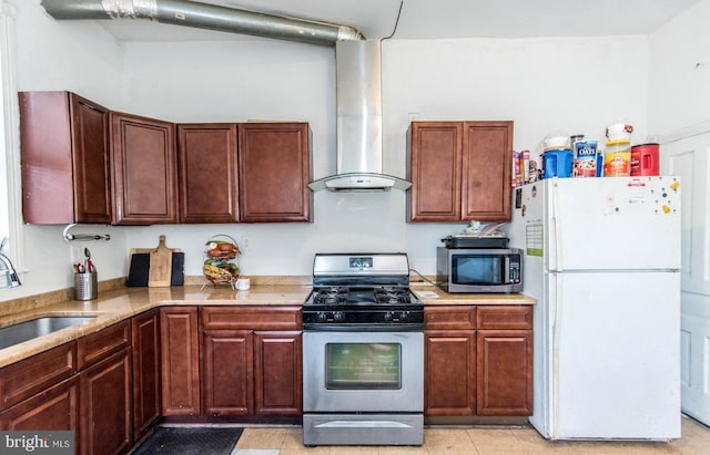 kitchen with a sink, light stone countertops, appliances with stainless steel finishes, and wall chimney exhaust hood