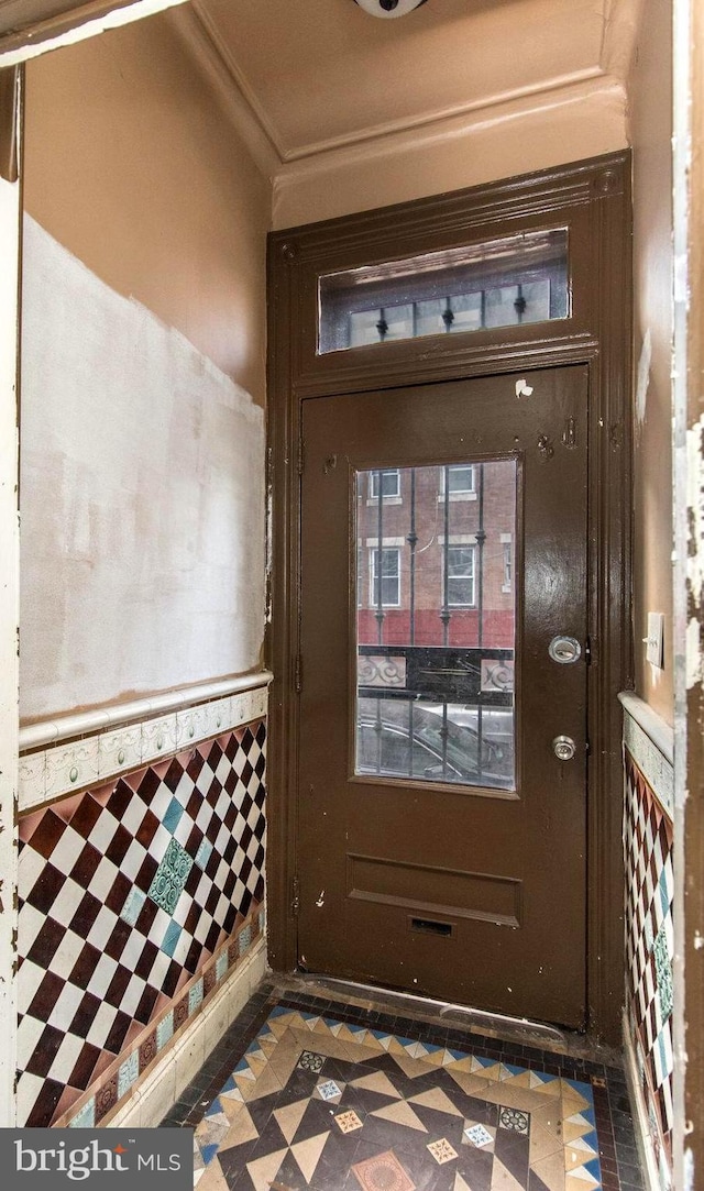 interior space with crown molding and tile patterned floors