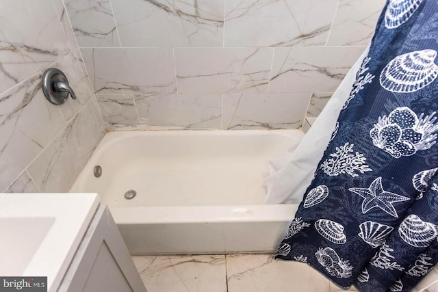 full bath featuring a bathing tub, marble finish floor, and a shower with shower curtain