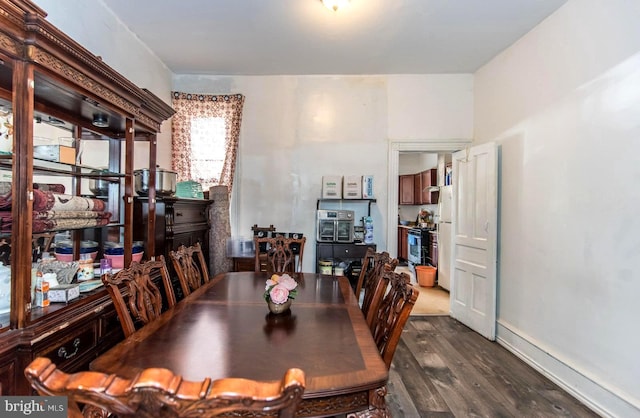 dining area featuring dark wood-style floors and baseboards