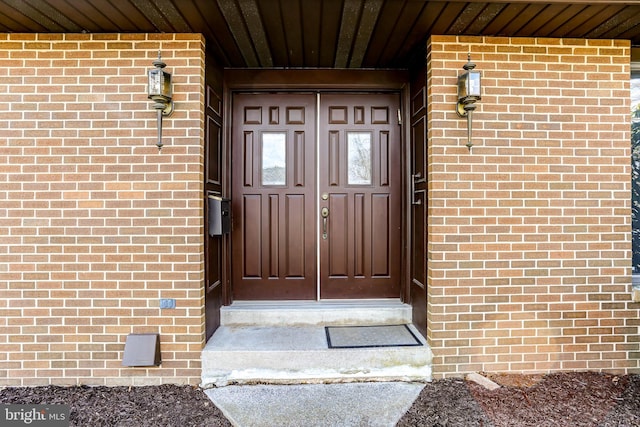 entrance to property with brick siding