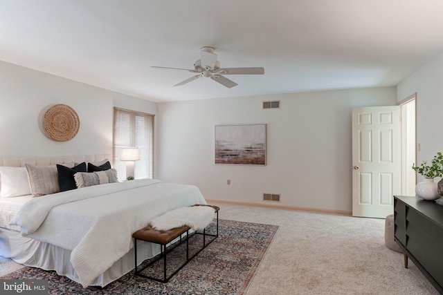 carpeted bedroom with visible vents, a ceiling fan, and baseboards