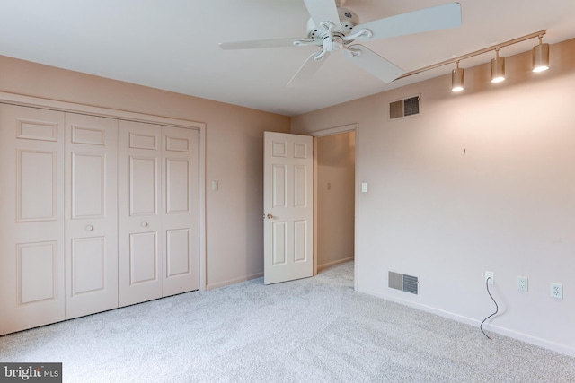 unfurnished bedroom featuring visible vents, baseboards, and carpet floors