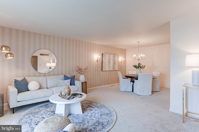 carpeted living area with wallpapered walls, visible vents, baseboards, and a chandelier