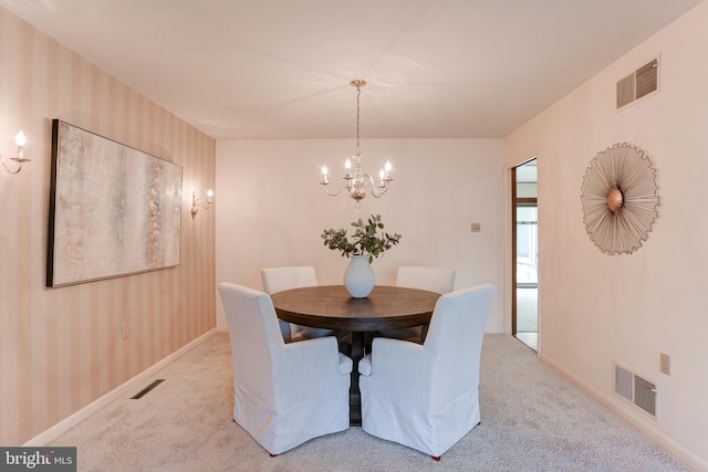 unfurnished dining area with visible vents, light carpet, an inviting chandelier, and wallpapered walls