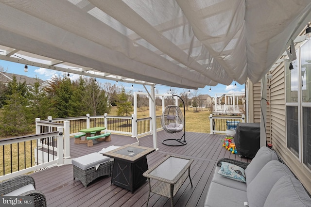 wooden terrace featuring area for grilling and outdoor lounge area