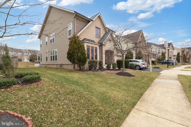 view of home's exterior featuring a lawn and a residential view