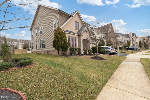 view of side of home with a residential view and a yard