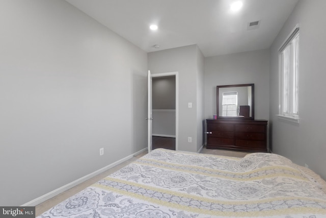 carpeted bedroom with recessed lighting, baseboards, and visible vents