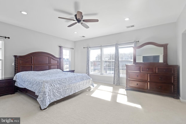 bedroom with a ceiling fan, recessed lighting, visible vents, and light carpet