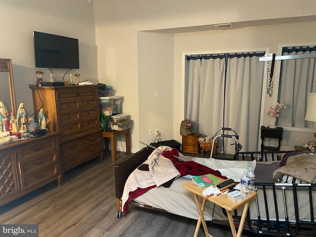 bedroom featuring visible vents and wood finished floors