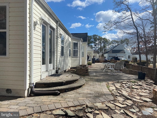 view of patio / terrace featuring entry steps and fence