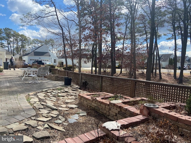 exterior space featuring a patio, fence, and a residential view