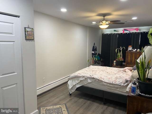 bedroom with visible vents, recessed lighting, wood finished floors, and a baseboard radiator