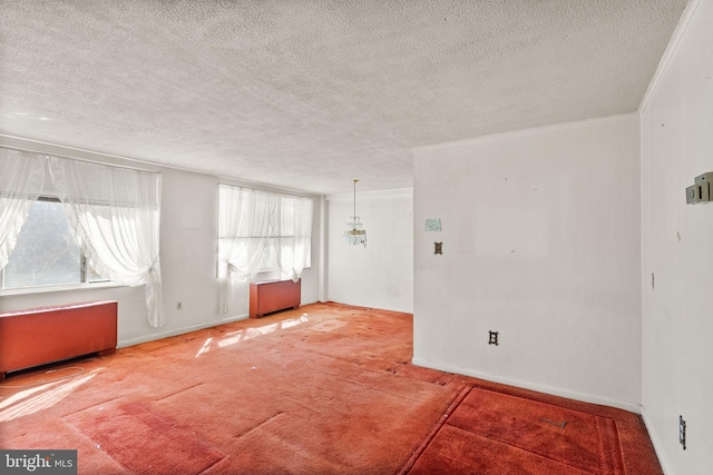 unfurnished room with baseboards, carpet floors, a textured ceiling, and crown molding