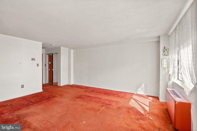 unfurnished room featuring baseboards, carpet floors, and a textured ceiling