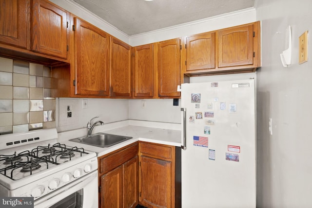 kitchen with light countertops, decorative backsplash, brown cabinets, white appliances, and a sink