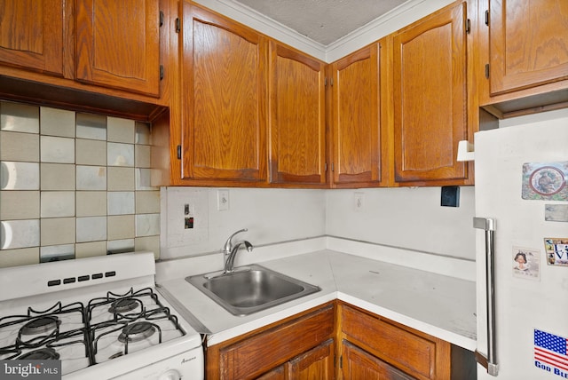 kitchen featuring brown cabinets, a sink, tasteful backsplash, white appliances, and light countertops