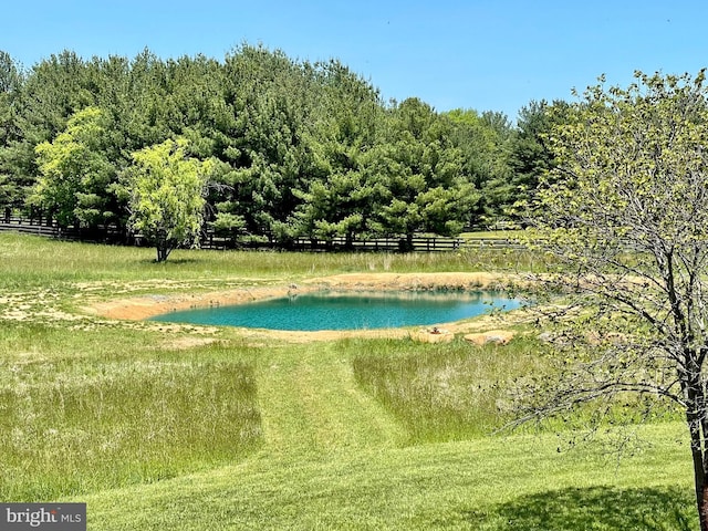 view of swimming pool featuring a water view