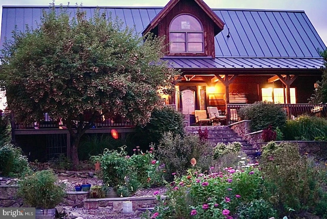 view of front of property with a porch, metal roof, and a standing seam roof