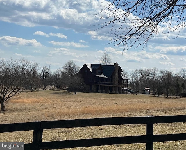 view of yard with a rural view and fence