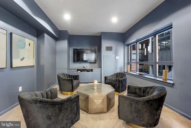 living area featuring light colored carpet, recessed lighting, baseboards, and visible vents