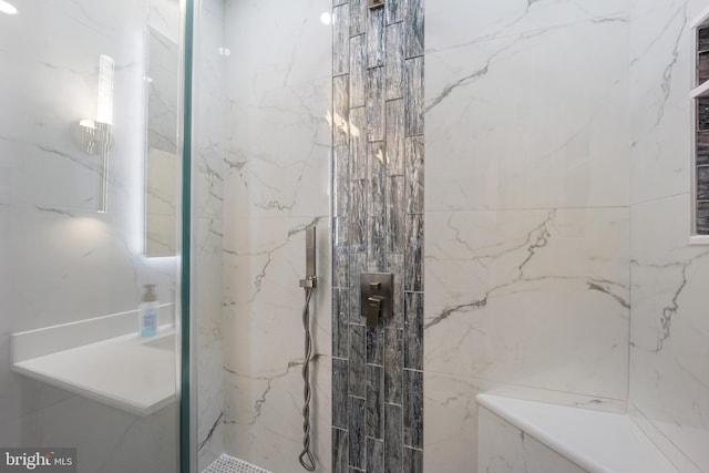 full bath with a marble finish shower