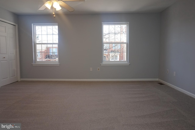 unfurnished room featuring baseboards, a ceiling fan, and carpet flooring