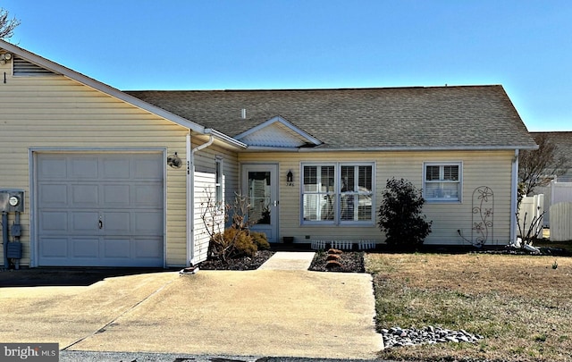 view of front of property featuring a garage, concrete driveway, and a shingled roof